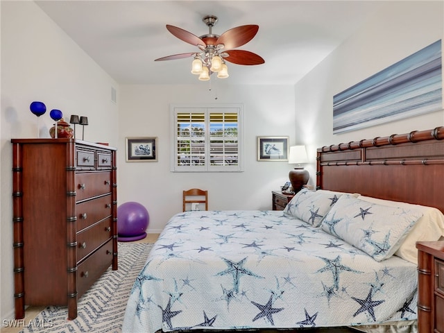 bedroom with a ceiling fan, baseboards, visible vents, and carpet floors