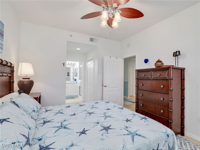 bedroom with visible vents, baseboards, a closet, ensuite bath, and a ceiling fan