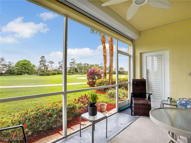 sunroom featuring a ceiling fan
