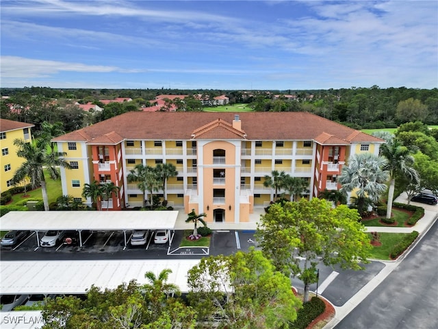 view of property with covered and uncovered parking
