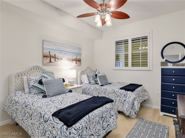 carpeted bedroom featuring a ceiling fan and baseboards