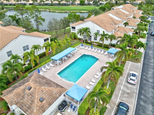 view of pool featuring a water view and a residential view