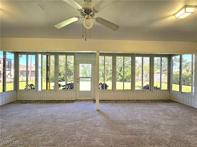 unfurnished sunroom with ceiling fan