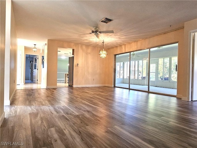 unfurnished room with ceiling fan, wood finished floors, and visible vents