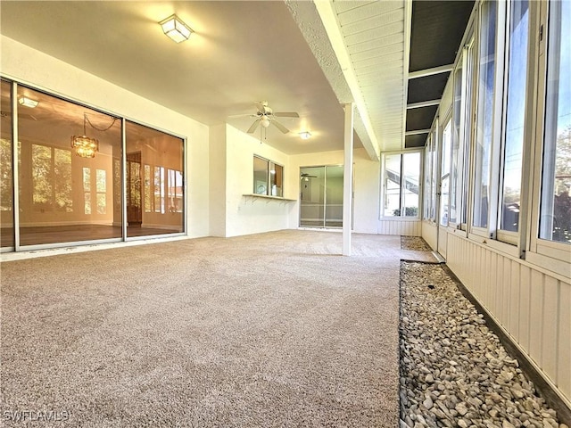 carpeted spare room with ceiling fan