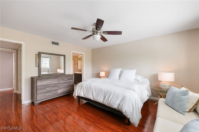bedroom featuring baseboards, visible vents, connected bathroom, ceiling fan, and dark wood-style flooring
