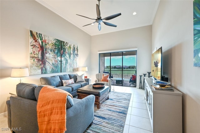 living area featuring a ceiling fan, ornamental molding, a high ceiling, light tile patterned flooring, and recessed lighting