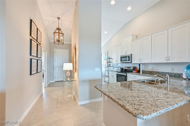 kitchen with stainless steel appliances, a peninsula, a sink, white cabinets, and light stone countertops