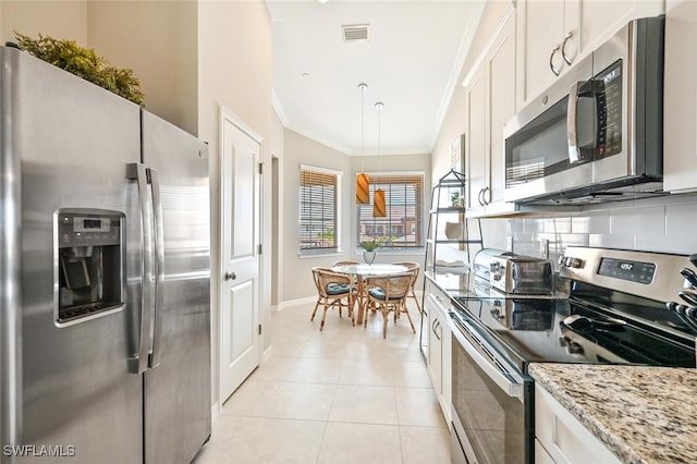 kitchen with visible vents, appliances with stainless steel finishes, light stone counters, white cabinetry, and pendant lighting