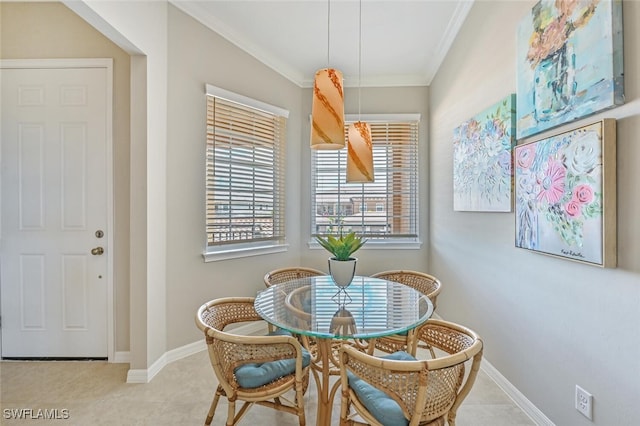 dining room featuring light tile patterned floors, baseboards, and ornamental molding