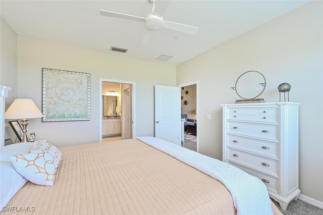 bedroom with visible vents, ceiling fan, baseboards, and ensuite bathroom