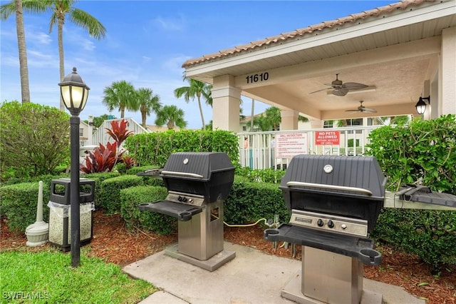 view of patio with grilling area, fence, and a ceiling fan