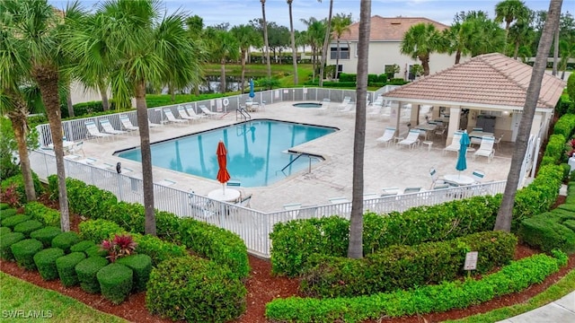 community pool featuring a patio area, fence, a hot tub, and a gazebo