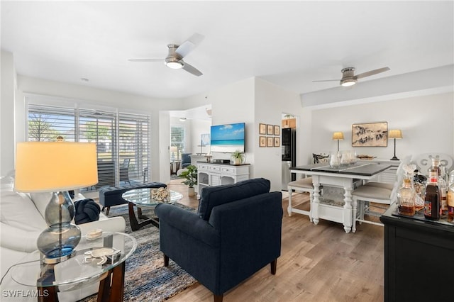 living room with a ceiling fan and wood finished floors