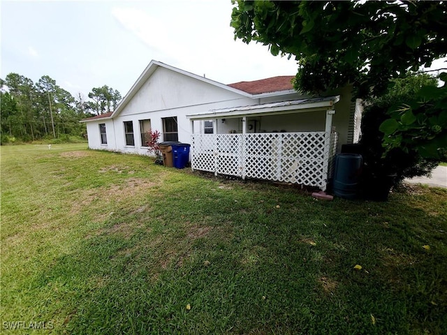 rear view of property featuring a yard