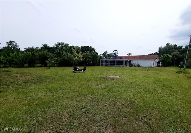 view of yard with glass enclosure