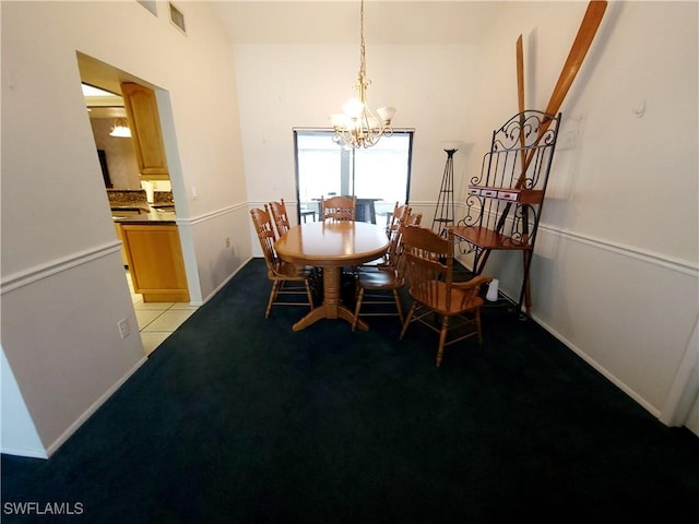 dining area featuring light tile patterned flooring, a notable chandelier, light carpet, visible vents, and baseboards