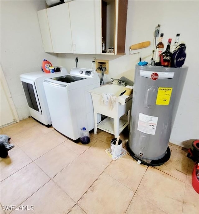 washroom with cabinet space, light tile patterned floors, water heater, separate washer and dryer, and a sink