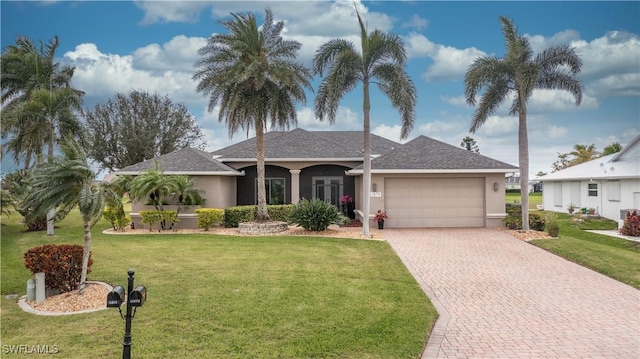 ranch-style home with an attached garage, stucco siding, decorative driveway, and a front yard