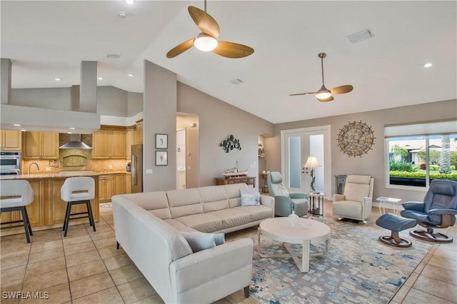 living area featuring visible vents, ceiling fan, and light tile patterned floors