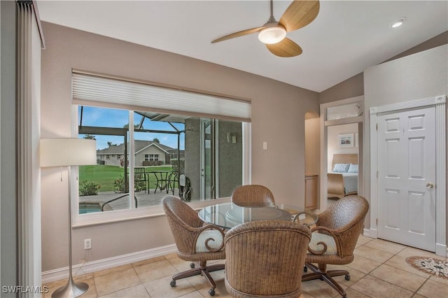 sitting room with lofted ceiling, ceiling fan, baseboards, and light tile patterned floors