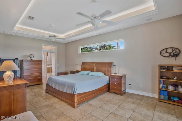 bedroom with baseboards, visible vents, a raised ceiling, ceiling fan, and ensuite bathroom