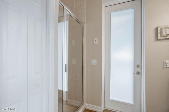 full bath featuring a closet and a shower stall