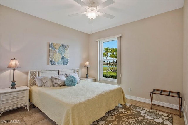 bedroom with light tile patterned floors, ceiling fan, and baseboards