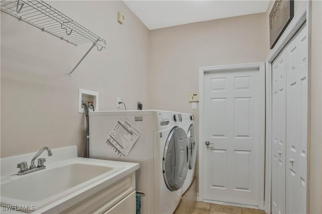 laundry room with washer and dryer, laundry area, a sink, and light tile patterned floors