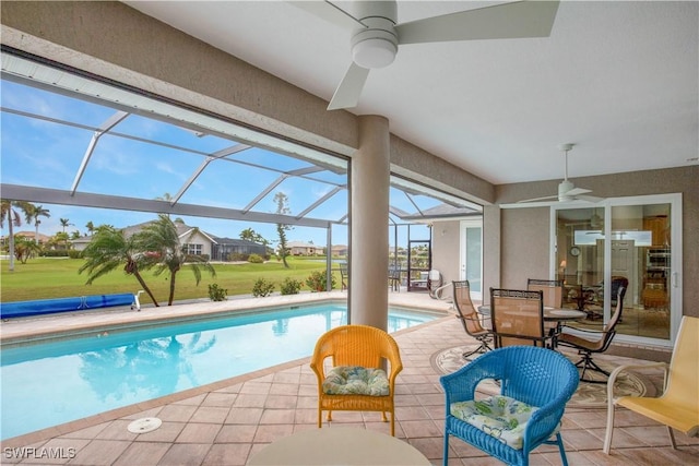 pool with a lanai, a patio area, and ceiling fan