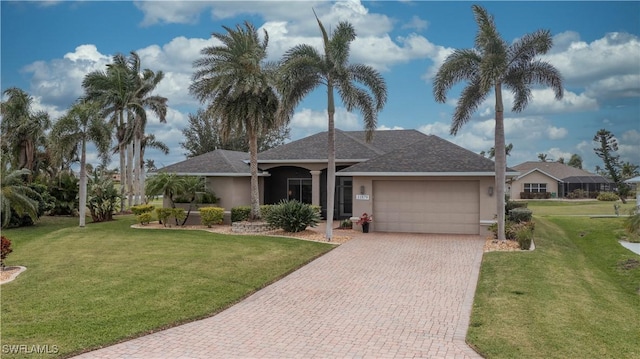 single story home with a garage, a front lawn, decorative driveway, and stucco siding