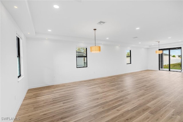 unfurnished room with a wealth of natural light, recessed lighting, baseboards, and light wood finished floors