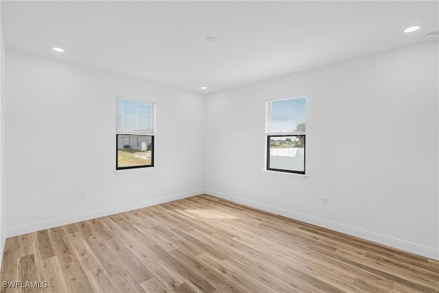 unfurnished room with recessed lighting, light wood-style flooring, and baseboards