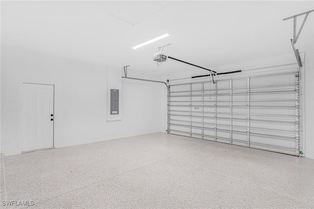 garage featuring electric panel and a garage door opener