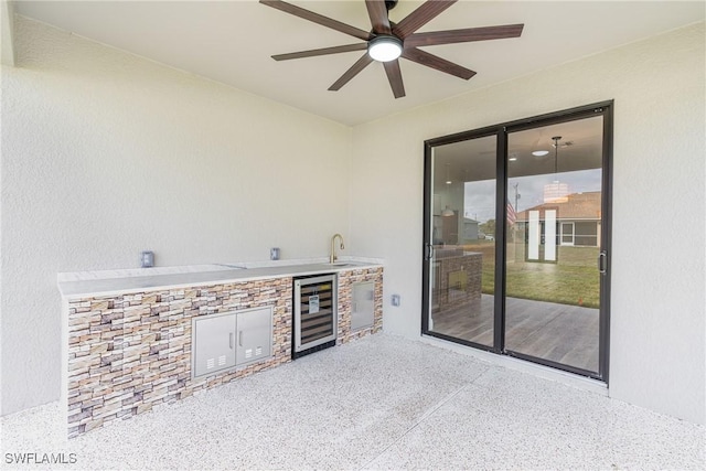 view of patio / terrace featuring ceiling fan, wine cooler, area for grilling, and a sink