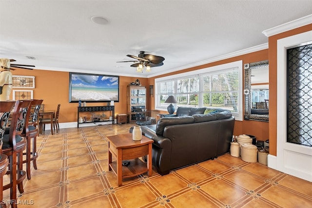 living room with visible vents, ornamental molding, a ceiling fan, and baseboards