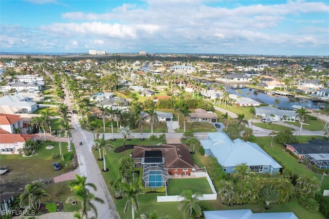 drone / aerial view with a residential view and a water view