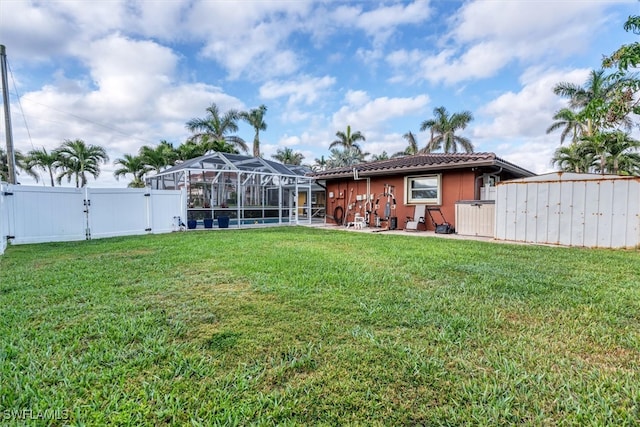 exterior space with glass enclosure, a fenced backyard, and a gate