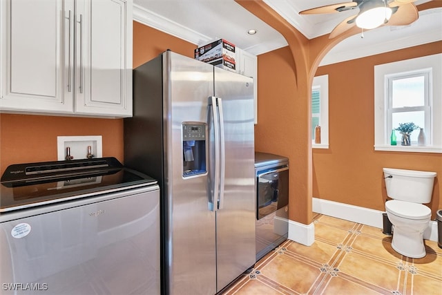 kitchen featuring stainless steel fridge, baseboards, a ceiling fan, ornamental molding, and white cabinetry