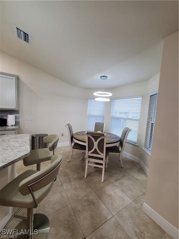 dining room featuring visible vents, baseboards, and light tile patterned floors