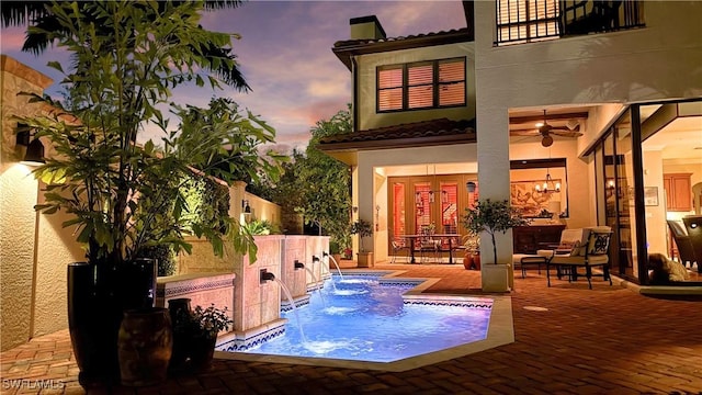 view of pool with ceiling fan and a patio