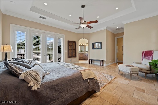 bedroom with stone tile floors, visible vents, baseboards, access to exterior, and a tray ceiling