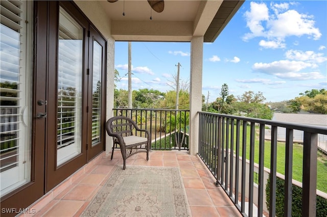 balcony with french doors and a ceiling fan