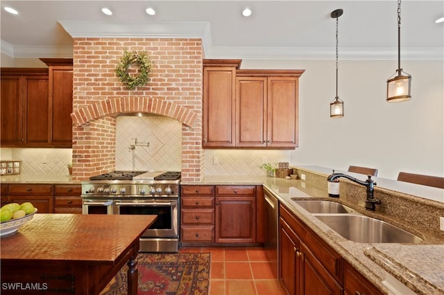 kitchen featuring light stone countertops, ornamental molding, stainless steel appliances, and a sink