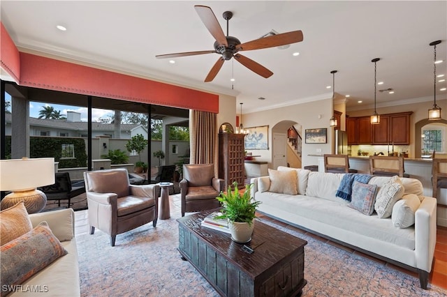 living room featuring stairway, arched walkways, a ceiling fan, and recessed lighting