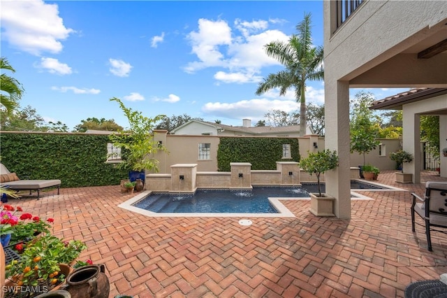 view of pool featuring a patio area and a fenced backyard