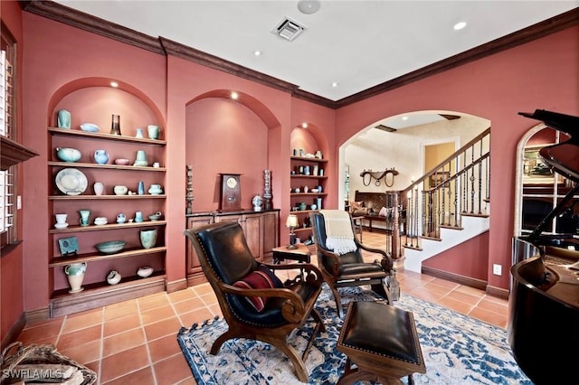 sitting room with light tile patterned floors, built in shelves, and baseboards