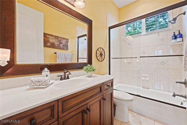 full bath featuring enclosed tub / shower combo, vanity, toilet, and tile patterned floors