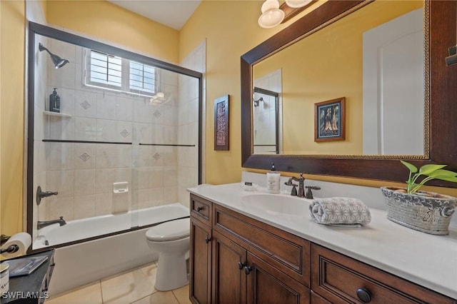 full bathroom with toilet, shower / bath combination with glass door, tile patterned flooring, and vanity