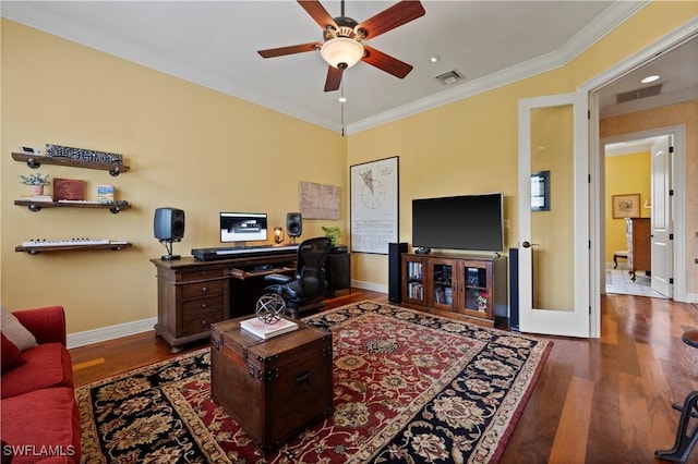 home office with ornamental molding, wood finished floors, visible vents, and baseboards